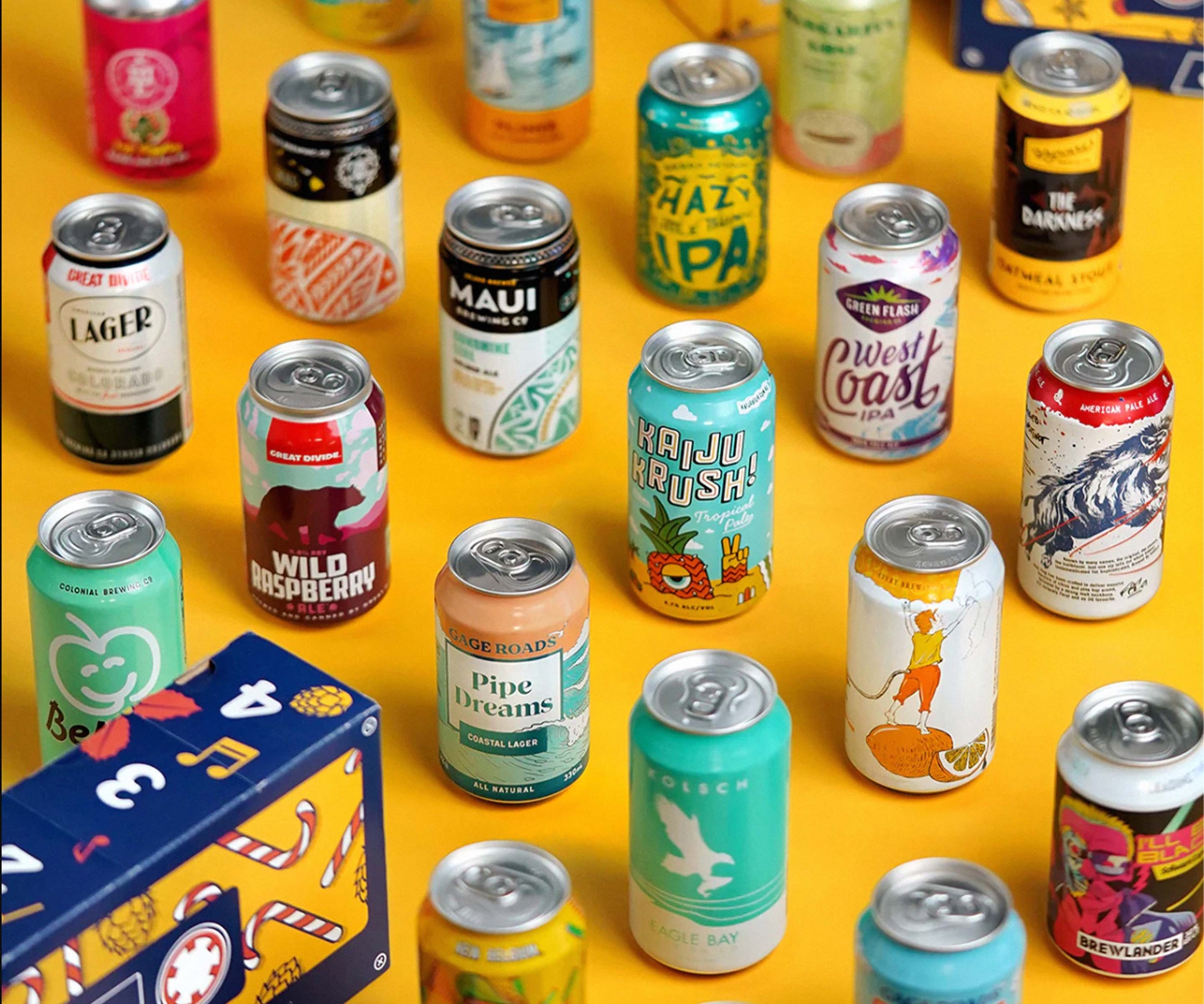 Many different cans of beer on yellow table